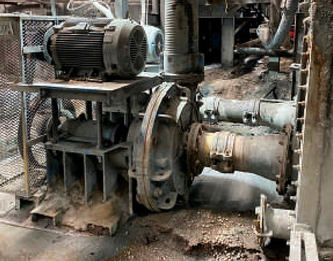 Bomba industrial o reductor con motor eléctrico en una planta. Componente pesado de maquinaria industrial.